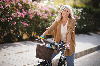 A woman riding a bicycle. Links to Tangible Personal Property