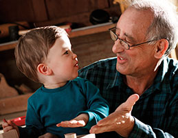 Photo of a man with his grandson. Links to Gifts from Retirement Plans